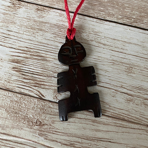 Carved Man Necklace on Red Cord
