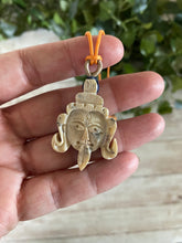 Load image into Gallery viewer, Carved Stone Kali Goddess Head Necklace with Orange Cord
